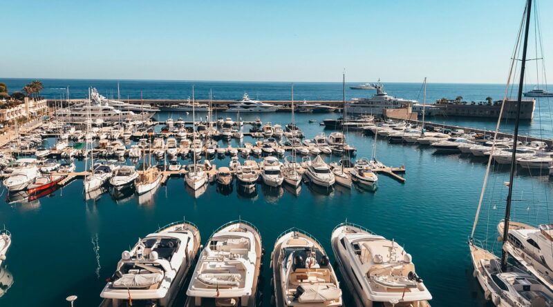 A stunning view of luxury yachts in the vibrant Monaco harbor under a clear sky.