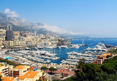 A stunning aerial view of Monte Carlo's marina with yachts and city buildings.