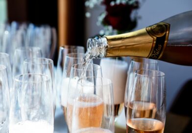 Elegant champagne being poured into flute glasses at a celebration or event.