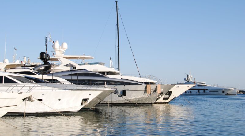 Elegant yachts docked at the marina in Cannes, showcasing luxury and design.