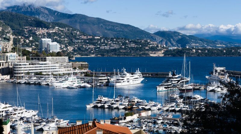 Breathtaking view of Monaco marina with luxurious yachts and scenic backdrop.