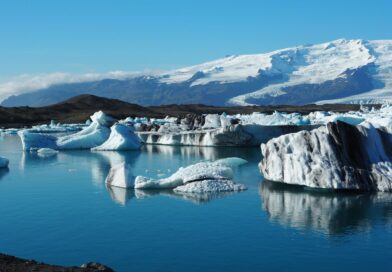 Breathtaking view of icebergs reflecting in the serene waters of Jökulsárlón glacier lagoon, Iceland.