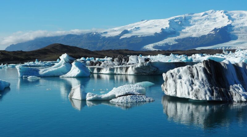 Breathtaking view of icebergs reflecting in the serene waters of Jökulsárlón glacier lagoon, Iceland.